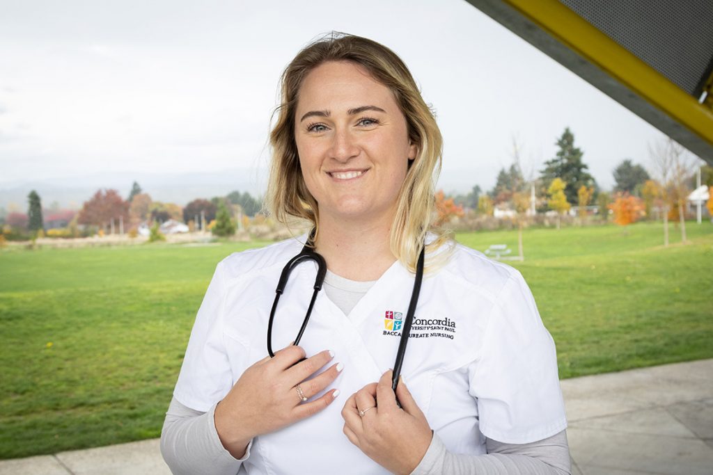 CSP ABSN student standing outside holding stethoscope