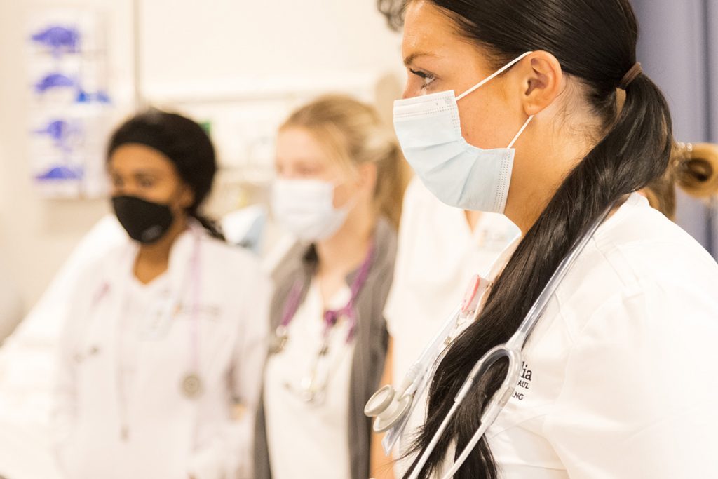 nursing students standing together in lab