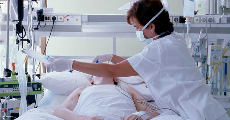 Nurse fixing patient oxygen mask